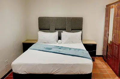 a bedroom with a large bed in a room at Central Perk Guesthouse in Pretoria