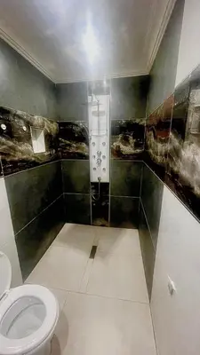 a bathroom with a toilet in a room at Central Perk Guesthouse in Pretoria