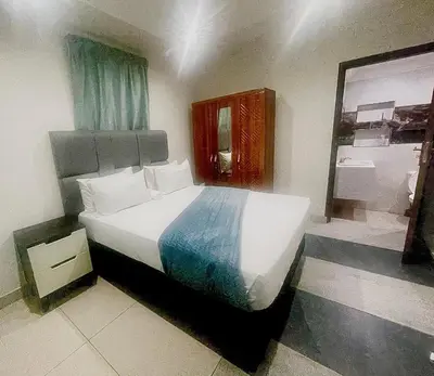 a bedroom with a large bed and a mirror at Central Perk Guesthouse in Pretoria