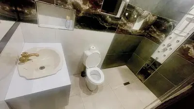 a bathroom with a toilet and a sink at Central Perk Guesthouse in Pretoria