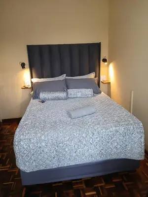 a large bed with two pillows on top of it at Rest at 54 Gladiator Guesthouse in Kempton Park