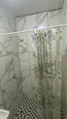 a bathroom with a shower with a shower curtain at Rest at 54 Gladiator Guesthouse in Kempton Park