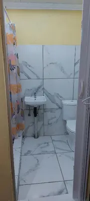 a bathroom with a sink and a toilet at Rest at 54 Gladiator Guesthouse in Kempton Park