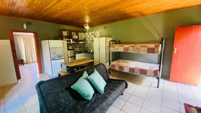 a living room with a couch and two bunk beds at Micnels B & B in Pretoria