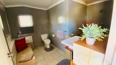 a small bathroom with a toilet and a sink at Micnels B & B in Pretoria