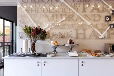 a kitchen with a white counter with food on it at Akanani Apartments in Pretoria