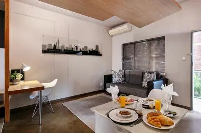 a living room with a table with food on it at Akanani Apartments in Pretoria