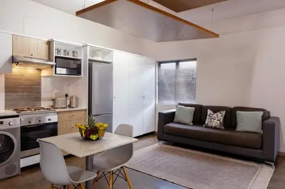 a living room with a couch and a table at Akanani Apartments in Pretoria