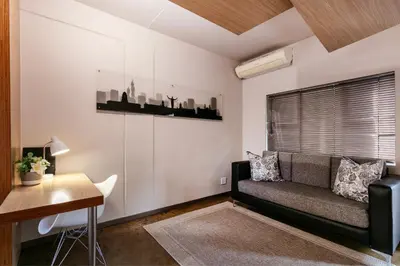 a living room with a couch and a table at Akanani Apartments in Pretoria