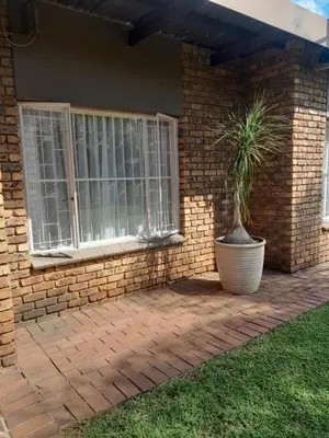 a house with a plant in a pot on a patio at 2 bedroom family friendly cosy & luxury home, walking distance to Doringkloof Mall in Centurion