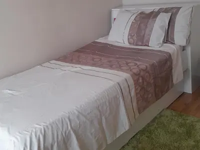 a bed in a small room with a white bedspread at 2 bedroom family friendly cosy & luxury home, walking distance to Doringkloof Mall in Centurion