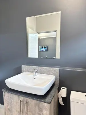 a bathroom with a sink and a mirror at Rachels Haven in Boschrand