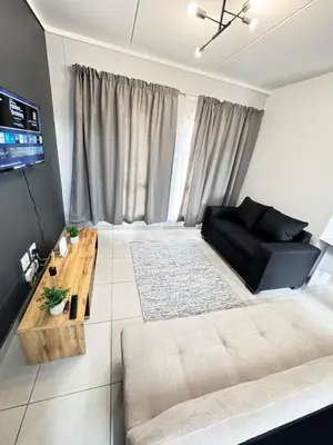 a living room with a bed and a couch at Rachels Haven in Boschrand