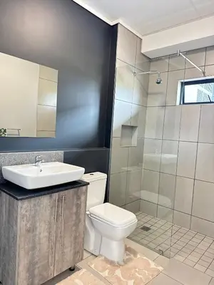 a bathroom with a toilet and a sink and a shower at Rachels Haven in Boschrand