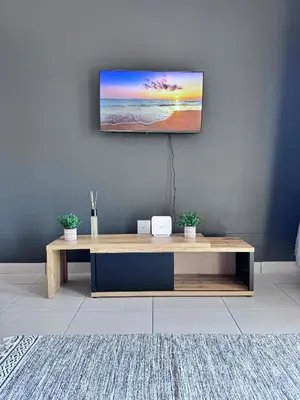 a living room with a tv on a wall at Rachels Haven in Boschrand
