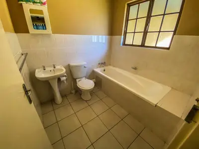 a bathroom with a toilet and a tub and a sink at Pandleberry in Warmbaths