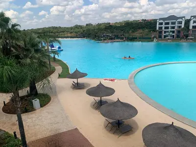 a large swimming pool with umbrellas and a pool at The Blyde Siesta in Pretoria