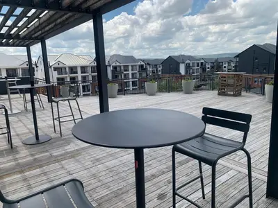 a patio with a table and chairs on a deck at The Blyde Siesta in Pretoria