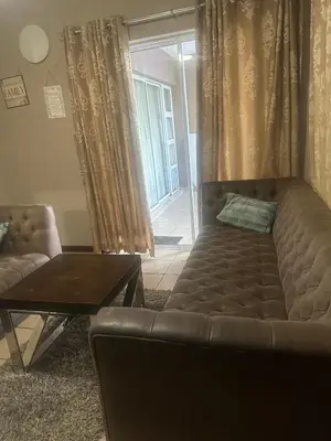 a living room with a couch and a table at Bytes - Waterberry Mbombela in Nelspruit
