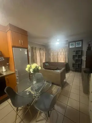 a living room with a table and a couch at Bytes - Waterberry Mbombela in Nelspruit