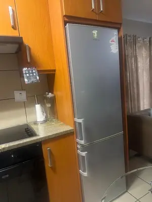 a stainless steel refrigerator in a kitchen at Bytes - Waterberry Mbombela in Nelspruit
