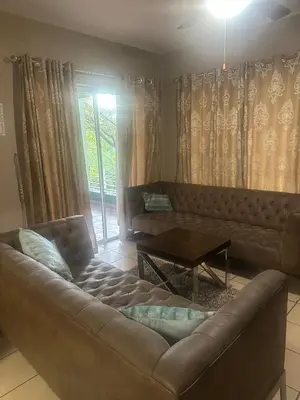 a living room with a couch and a table at Bytes - Waterberry Mbombela in Nelspruit