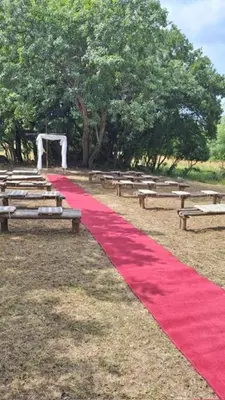 a red graduation ceremony with benches and a red carpet at Klipspringer Lodge in Nelspruit