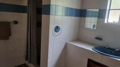a bathroom with a sink and a mirror at Klipspringer Lodge in Nelspruit