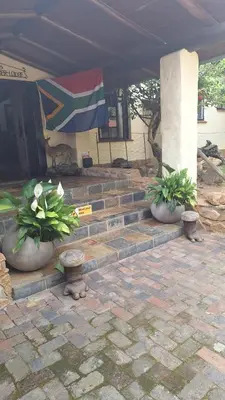 two potted plants sitting on steps under a tent at Klipspringer Lodge in Nelspruit