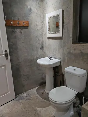 a bathroom with a toilet and a sink at Skuinslê in Centurion