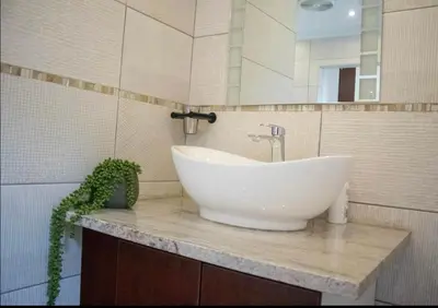 a bathroom with a white sink and a mirror at Private Room Kosmosdal in Centurion