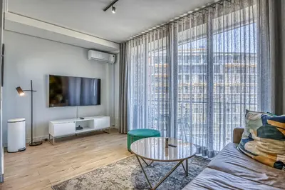 a living room with a couch and a table at Celestial Cassini Cove at The Ellipse in Midrand