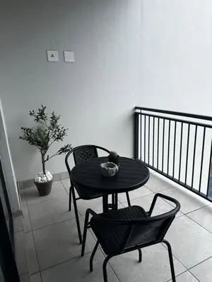 a table and two chairs on a balcony with a table and chairs at Waterfall Luxury Apartment in Midrand