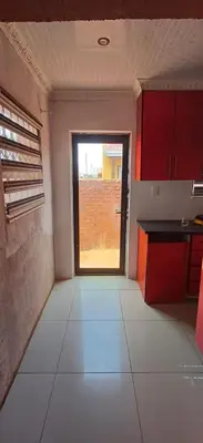 a room with a kitchen with a window in it at Siba's Place in Ga-Rankuwa