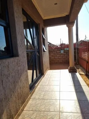 an empty porch of a building with glass doors at Siba's Place in Ga-Rankuwa