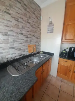 a kitchen with a sink and a counter top at TANS - 1 bedroom luxury & cosy home walking distance to Doringkloof Mall in Centurion