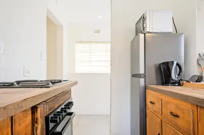 a kitchen with a refrigerator and a counter top at Waterfall Views in Midrand