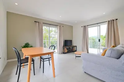 a living room with a table and a couch at Waterfall Views in Midrand