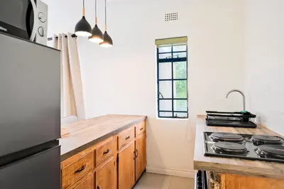 a kitchen with a counter top and a stove at Waterfall Views in Midrand