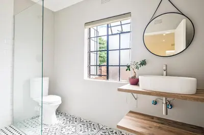 a bathroom with a sink and a mirror at Waterfall Views in Midrand