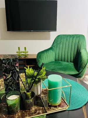 a living room with a green couch and a table at The Blyde Lagoon in Pretoria