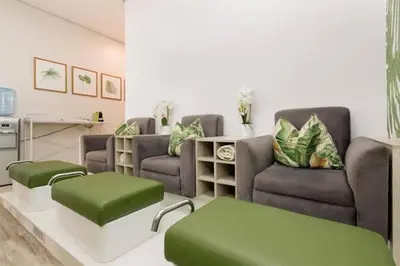 a living room with two couches and green ottoman at The Blyde Lagoon in Pretoria