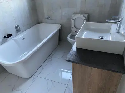 a bathroom with a tub and a toilet and a sink at 36 on EAGLE DRIVE in Modimolle