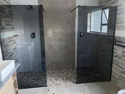 a bathroom with a shower with a glass door at 36 on EAGLE DRIVE in Modimolle