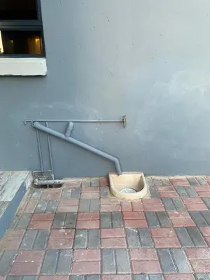 a bathroom with a toilet on a tiled floor at 36 on EAGLE DRIVE in Modimolle