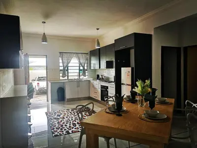a kitchen with a wooden table in a room at Moll & Kie Luxury Accommodation in Burgersfort