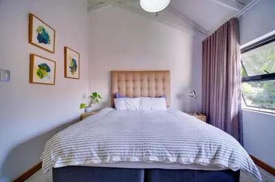 a bedroom with a large bed and a window at Brooklyn Self Catering - walking distance to University of Pretoria in Pretoria