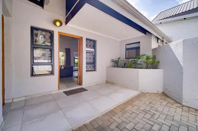 an empty house with a door and a porch at Brooklyn Self Catering - walking distance to University of Pretoria in Pretoria