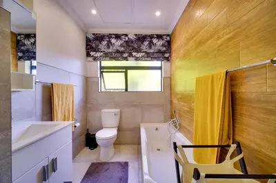 a bathroom with a toilet and a sink and a tub at Brooklyn Self Catering - walking distance to University of Pretoria in Pretoria