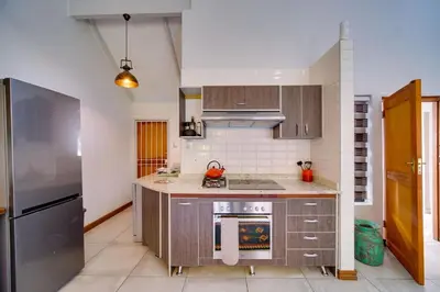 a kitchen with a stainless steel refrigerator and cabinets at Brooklyn Self Catering - walking distance to University of Pretoria in Pretoria